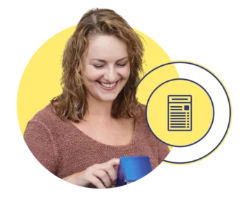 Woman smiling as she reads a nutrition label